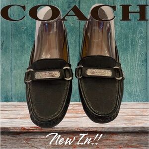Coach Felicia women’s black flat signature jacquard loafers with silver ID logo.